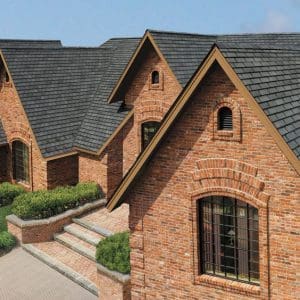 A beautiful home with brick siding and a shingle roof