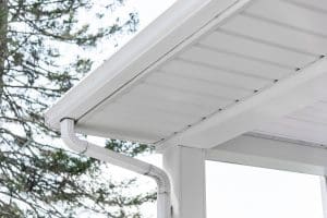 Gutter system is installed on the white colored house 